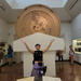 Student Barton raising hands up in the air at the museum