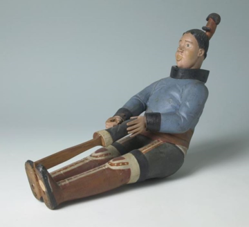 Model of an Inuit woman using a 'Kameo' to soften her sealskin boots Model of an Inuit woman using a 'Kameo' to soften her sealskin boots