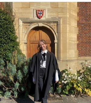 Full figure image of student Lawson in front of door in Jesus College College, Cambridge 